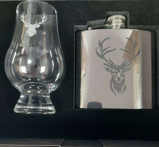 Stainless steel flask and glass with deer etching on a black background